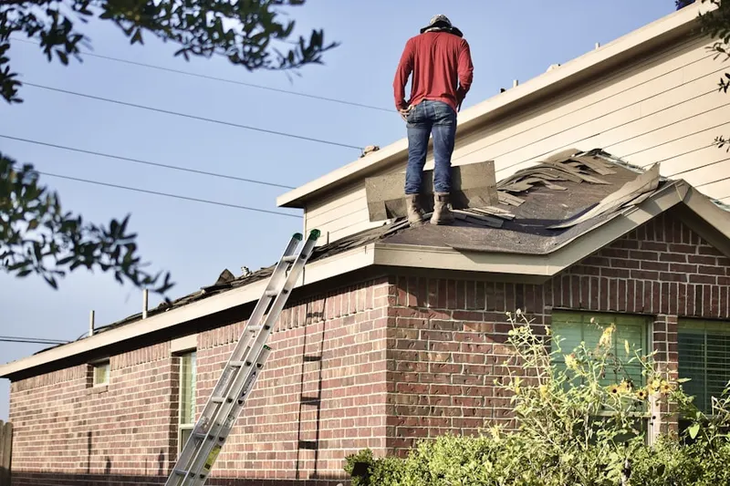 Professional roofer working on a residential roof in Porter